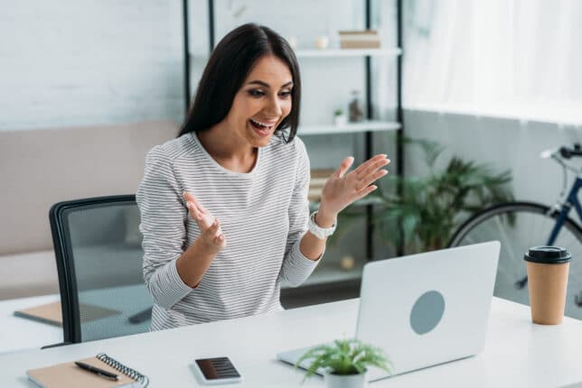 happy and beautiful woman having online dating in apartment